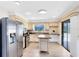 Bright kitchen featuring stainless steel appliances and a breakfast bar at 1736 Saxon Blvd, Deltona, FL 32725