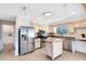 Well-lit kitchen featuring stainless steel appliances, light cabinets, and a center island at 1736 Saxon Blvd, Deltona, FL 32725