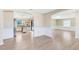 Open living space leading to the kitchen with light wood floors at 1736 Saxon Blvd, Deltona, FL 32725