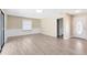 Spacious living room with neutral walls, base trim, and new flooring at 1736 Saxon Blvd, Deltona, FL 32725
