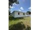 The home's backyard features a large lawn and a privacy fence at 1754 35Th Nw St, Winter Haven, FL 33881