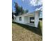 The home's backyard features a covered lanai and large lawn at 1754 35Th Nw St, Winter Haven, FL 33881