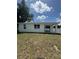 The home's backyard features a large lawn at 1754 35Th Nw St, Winter Haven, FL 33881