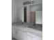 This bathroom boasts double sinks with white cabinets and light countertops at 1754 35Th Nw St, Winter Haven, FL 33881