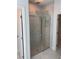 Large shower features glass doors and marble tile for an elegant look at 1754 35Th Nw St, Winter Haven, FL 33881