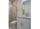 Modern bathroom features tiled shower with glass door, white vanity, and neutral walls at 1754 35Th Nw St, Winter Haven, FL 33881