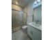 Modern bathroom features tiled shower with glass door, white vanity, and neutral walls at 1754 35Th Nw St, Winter Haven, FL 33881