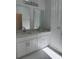 Bathroom boasts double sinks with light countertops and chrome hardware at 1754 35Th Nw St, Winter Haven, FL 33881
