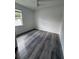 Light and airy bedroom with gray wood-look flooring and a bright window at 1754 35Th Nw St, Winter Haven, FL 33881