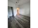 Spacious bedroom with gray wood-look flooring and ceiling fan at 1754 35Th Nw St, Winter Haven, FL 33881