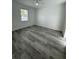 Bright bedroom featuring wood-look floors, a ceiling fan, and a large window at 1754 35Th Nw St, Winter Haven, FL 33881