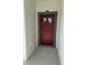 Close up of a bold red front door with glass insert and grey trim at 1754 35Th Nw St, Winter Haven, FL 33881