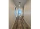 Hallway features beautiful wood-look flooring and recessed lighting at 1754 35Th Nw St, Winter Haven, FL 33881