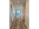 Hallway with wood-look flooring leading to an open concept kitchen and living area at 1754 35Th Nw St, Winter Haven, FL 33881