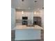 Modern kitchen with island, stainless steel appliances and fixtures, plus white cabinetry and countertops at 1754 35Th Nw St, Winter Haven, FL 33881