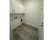 Practical laundry room with overhead cabinets and modern flooring at 1754 35Th Nw St, Winter Haven, FL 33881