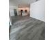 Living room and kitchen with light wood-look floors and a bright, open layout at 1754 35Th Nw St, Winter Haven, FL 33881