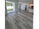 Living room featuring sliding glass doors to the backyard and light wood-look flooring at 1754 35Th Nw St, Winter Haven, FL 33881