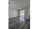 Empty living room with sliding glass doors, recessed lighting, and light wood-look flooring at 1754 35Th Nw St, Winter Haven, FL 33881