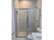Modern glass door shower with attractive marble-look tile and pebble floor at 1754 35Th Nw St, Winter Haven, FL 33881