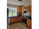 Well-lit kitchen boasting stainless steel appliances, and ample cabinet space at 1791 Iroquois Dr, Apopka, FL 32703