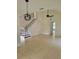 Open-concept living room with tile flooring, a staircase, and modern lighting fixtures at 1791 Iroquois Dr, Apopka, FL 32703