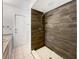 Modern bathroom with a tiled shower, glass shelving, and updated fixtures at 1818 Portview Ave, Deltona, FL 32738
