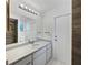 Bright bathroom featuring a wide mirror and clean, tiled shower at 1818 Portview Ave, Deltona, FL 32738