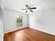Simple bedroom with hardwood floors, ceiling fan, and natural light at 1818 Portview Ave, Deltona, FL 32738