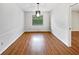 Cozy dining room with hardwood floors and a modern light fixture at 1818 Portview Ave, Deltona, FL 32738