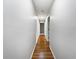 Long hallway with hardwood floors leading to various rooms at 1818 Portview Ave, Deltona, FL 32738