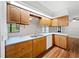 Functional kitchen with wooden cabinets, modern appliances, and lots of natural light from the skylight at 1818 Portview Ave, Deltona, FL 32738