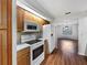 Functional kitchen with white appliances and connecting dining area at 1818 Portview Ave, Deltona, FL 32738