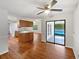 Inviting living room with hardwood floors, ceiling fan, and pool views at 1818 Portview Ave, Deltona, FL 32738