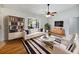 Bright living room features a stylish black and white rug, modern furniture and a ceiling fan at 1818 Portview Ave, Deltona, FL 32738