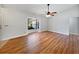 Spacious room with hardwood flooring and ceiling fan, filled with natural light from the large window at 1818 Portview Ave, Deltona, FL 32738