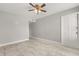 Neutral-painted bedroom with tile flooring, a ceiling fan, and a spacious closet at 1924 Lake Atriums Cir # 52, Orlando, FL 32839
