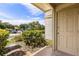 A unit entrance features neutral siding, trimmed hedges and a cement patio at 1924 Lake Atriums Cir # 52, Orlando, FL 32839