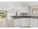 Modern kitchen with granite countertops, white cabinetry and new appliances including a dishwasher at 1924 Lake Atriums Cir # 52, Orlando, FL 32839
