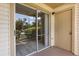 A covered patio with sliding glass doors and an additional entrance door at 1924 Lake Atriums Cir # 52, Orlando, FL 32839
