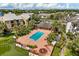 Aerial view of the community pool, clubhouse and meticulously landscaped grounds at 1924 Lake Atriums Cir # 52, Orlando, FL 32839