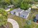 An aerial view of a cozy one-story home with a circular driveway and a spacious backyard at 219 E Fern Dr, Orange City, FL 32763