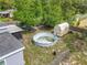 An aerial view showcases the spacious backyard with above ground pool, multiple storage sheds and shaded trees at 219 E Fern Dr, Orange City, FL 32763