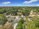From an aerial perspective, the property showcases well-maintained homes, mature trees, an above ground pool and multiple storage sheds at 219 E Fern Dr, Orange City, FL 32763