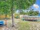 Backyard with above ground pool, sheds, and yard with mature shade trees at 219 E Fern Dr, Orange City, FL 32763
