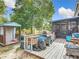 Backyard features a wooden deck with outdoor grill and fire pit, a shed and enclosed sunroom at 219 E Fern Dr, Orange City, FL 32763