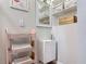 Compact bathroom showcasing a small sink, shelving, and white fixtures at 219 E Fern Dr, Orange City, FL 32763