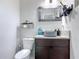 A bathroom showcases a vessel sink, modern vanity, neutral decor, and a sleek minimalist design at 219 E Fern Dr, Orange City, FL 32763