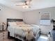 Comfortable bedroom with ceiling fan, laminate wood flooring and natural light at 219 E Fern Dr, Orange City, FL 32763