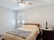 This bedroom features a ceiling fan, a neutral color scheme, and a cozy atmosphere at 219 E Fern Dr, Orange City, FL 32763